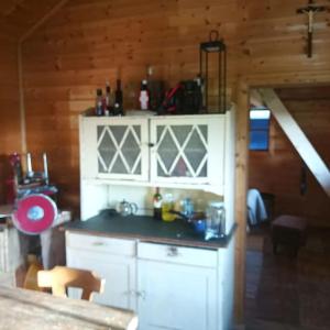 a kitchen with white cabinets and a counter top at Almhütte in Alleinlage in Puchenstuben