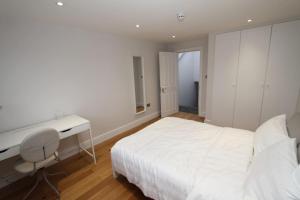 a white bedroom with a desk and a bed at Amazing Loft One Bedroom Apartment - E17 Village in London