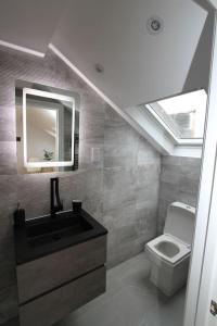a bathroom with a sink and a toilet at Amazing Loft One Bedroom Apartment - E17 Village in London