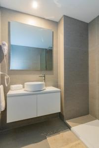 W łazience znajduje się biała umywalka i lustro. w obiekcie InSoho by iPPA w BuenosAires