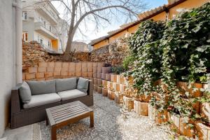 a couch sitting on a patio next to a wall at Yankı Otel in Çekirge