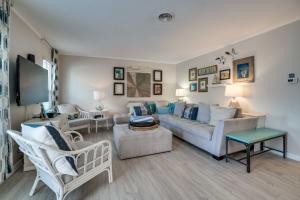 a living room with a couch and chairs at Relax Just Steps to the Soft White Sandy Beach, Heated Pool in Holmes Beach