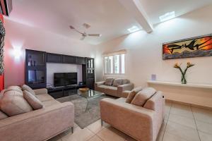 a living room with two couches and a tv at 3035 - Chantico 202 in Santa Cruz Huatulco