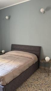 a bed in a bedroom with a white wall at Anna House in Cosenza +6 photos