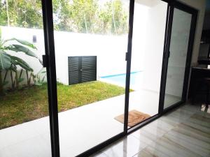 a glass door with a view of a pool at Airport Bed and Breakfast in Cancún
