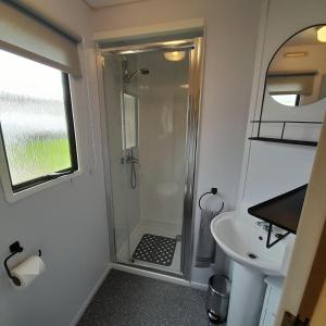 a bathroom with a shower and a sink at Yarborough View 1 Whitecliff Bay Bembridge Isle of Wight in Bembridge