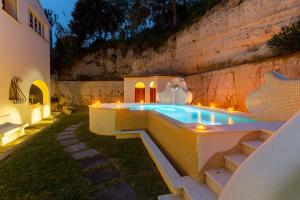a hot tub in a backyard with lights at Villa Le Pagine Bianche in Lacco Ameno