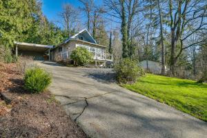 a house on a street with a driveway at Renton Home with Fire Pit and Nearby Lake Access! in Renton