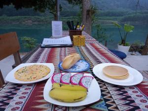 a picnic table with plates of food on it at Little Rock Homestay in Phong Nha