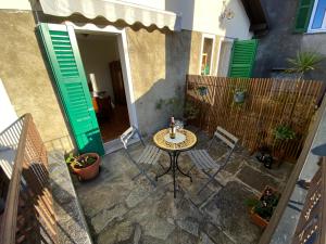 a patio with a table and chairs in front of a house at CHIAVE DI VOLTA Lovely Guesthouse with Terrace in Varenna