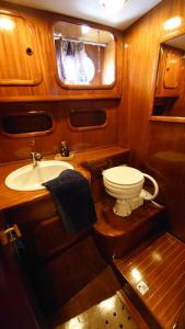 a small bathroom with a toilet and a sink at Bed & Breakfast & Sea with Captain in Pirovac