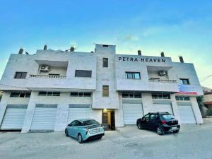 a building with two cars parked in front of it at Petra Heaven Boutique in Wadi Musa