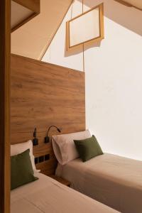 a bedroom with two beds and a light fixture at Wecamp San Sebastián in San Sebastián