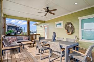 a patio with a table and chairs and a couch at Mills Fishing Cabin in Port Aransas