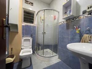 a bathroom with a shower and a toilet and a sink at Captivating 3-Bed House in Kigali Rwanda in Kigali +13 photos