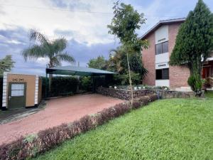 a patio with a blue umbrella in front of a building at Captivating 3-Bed House in Kigali Rwanda in Kigali