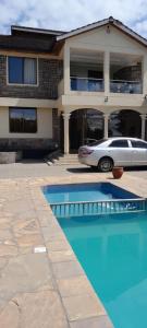 a car parked in front of a house at Twiga Whitehouse Villas in Nakuru