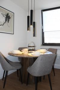 una sala da pranzo con tavolo e sedie in legno di Boutique Wohnung mit Domblick a Paderborn