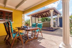a patio with a table and chairs and a gazebo at NEW ! Casa Kudawecha in Noord