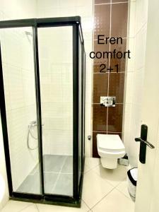 a bathroom with a shower and a toilet at IMC Fatih Apartments in Istanbul