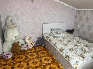 a bedroom with stuffed animals sitting next to a bed at Ashtarak Nor Tun in Ashtarak