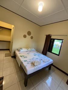 a bedroom with a bed and a window at Mingche Apartment in Panglao