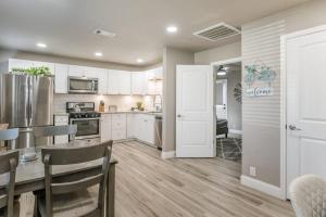 a kitchen with white cabinets and a table and chairs at Amazing Hot tub l Sleeps 14 in Amarillo