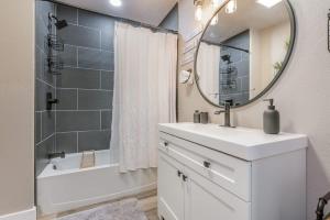 a bathroom with a sink and a mirror and a tub at Amazing Hot tub l Sleeps 14 in Amarillo
