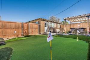 a yard with a putting green with a house at Amazing Hot tub l Sleeps 14 in Amarillo