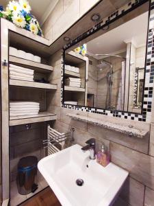 a bathroom with a sink and a mirror at M&R apartmani Rovinj in Rovinj