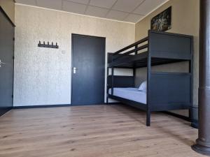 a bunk bed in a room with a doorway at B&B 't Kloaster in Hulsberg