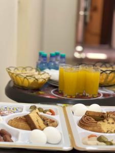 a table with plates of food and glasses of orange juice at Petra Heaven Boutique in Wadi Musa