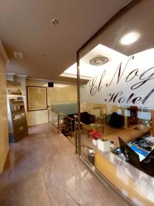 a room with a table and a glass window at Hotel El Nogal in Valladolid