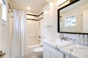 une salle de bain blanche avec un lavabo et un miroir dans l'établissement Port Orchard Guest House - Walk to Bay Street!, à Port Orchard