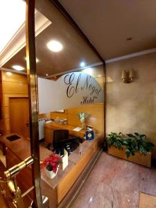 an office with a desk and a sign on the wall at Hotel El Nogal in Valladolid