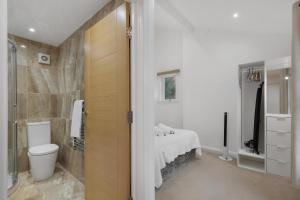 a bathroom with a bed and a shower and a toilet at Central and Modern One Bedroom Flat 201 in Oxford