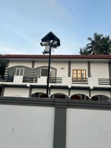 a building with a street light in front of it at Augustin Guest House in Point Pedro
