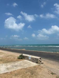 a view of the beach with the ocean in the background at Augustin Guest House in Point Pedro