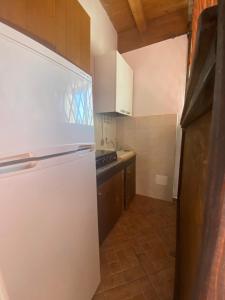 a kitchen with a white refrigerator in a room at Michelangelo's House in Gioiosa Marea