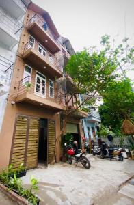 una casa con una motocicleta estacionada frente a ella en May's house (Nhà của Mây) en Hanói