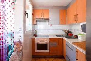 a little girl is standing in a kitchen at Valencia Penthouse Sunrise in Valencia