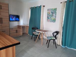 a living room with a table and two chairs at Plein Soleil in Grand Baie