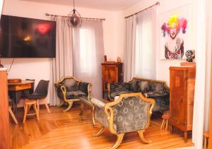 a living room with two couches and a table at The Acropolis House of Flowers~Private Roof Garden in Athens