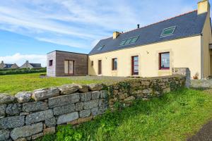 a stone wall in front of a house at Ty Jane Dour - Maison avec jardin in Plouhinec