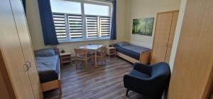 a room with a bed and a table and a window at Gästehaus Heinrich Heine Schule in Bad Dürrenberg