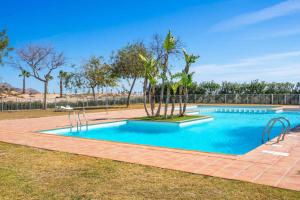 ein Schwimmbad in der Mitte eines Gartens in der Unterkunft Casa Naranja, A Simply Spanish Rentals Property in Murcia