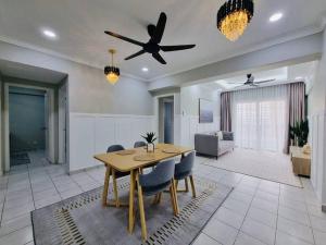 a living room with a dining table and a ceiling fan at Have a good Rest in Kajang