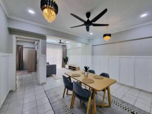 a dining room with a table and a ceiling fan at Have a good Rest in Kajang