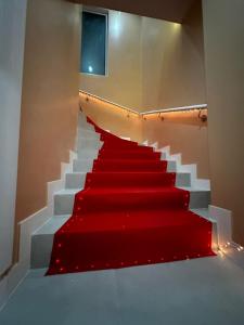 a red carpeted staircase with a red carpet at Crownn - Spa Privatif in Fontenay-sous-Bois