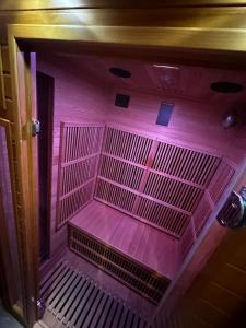 a purple room with a cage in a room at Crownn - Spa Privatif in Fontenay-sous-Bois